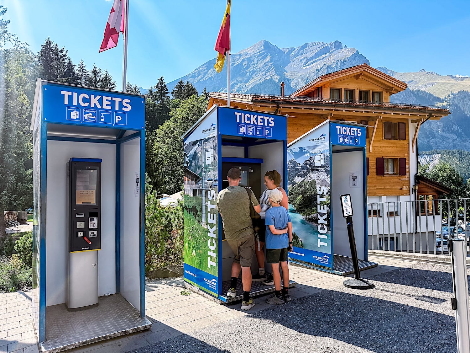 3 ticket machines in front on a wooden cabin an a mountain