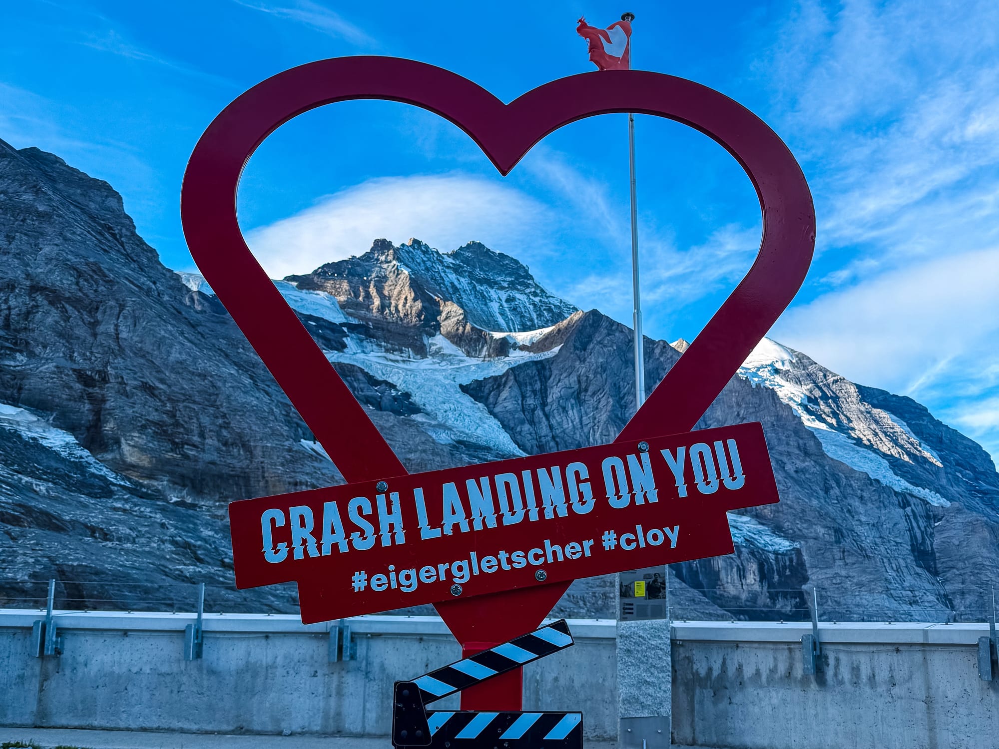 Heart-shaped "Crash Landing on You" photo frame at Eigergletscher with the Mönch and Eiger behind