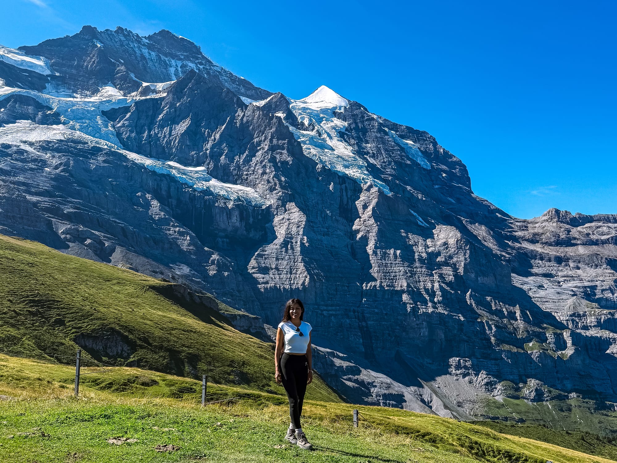 Hiker at the unofficial photo stop on the trail to Kleine Scheidegg, with the Eiger Glacier behind